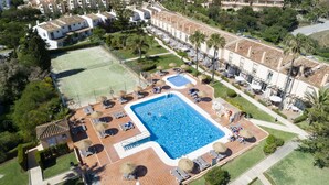 An aerial view of a resort with multiple buildings, a swimming pool, tennis courts, and landscaped areas. - AS MDS 113 in Mijas Costa (Mijas)