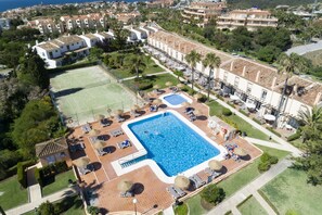 An aerial view of a resort with multiple buildings, a swimming pool, tennis courts, and landscaped areas. - AS MDS 113 in Mijas Costa (Mijas)