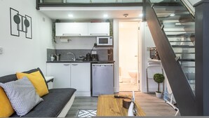 A modern apartment with a kitchen, dining area, and a staircase. - Studio in Central Reading- Next to Town Centre (Reading)