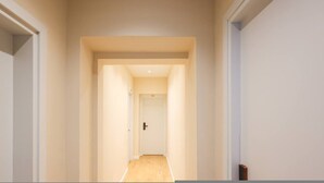 A narrow hallway with a door at the end, leading to a room with a visible door handle. - Grandstay Tirana Central 01 (Tiranë)