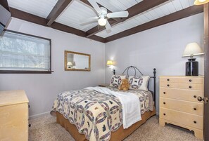 A bedroom with a bed, a ceiling fan, a dresser, and a window with blinds. - *Amazing 3BD w/ Hot Tub | Fire Pit + Pool Access* (Gatlinburg)