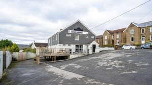 A building with a sign reading 'The NEW Lodge.' - Single Room • Fridge • Microwave • Parking (Pontardawe)