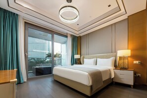 A modern hotel room with a large bed, a nightstand with a lamp, a sliding glass door to a balcony, and a chandelier. - YanShe Oceanview Resort Haitang Bay (Sanya)