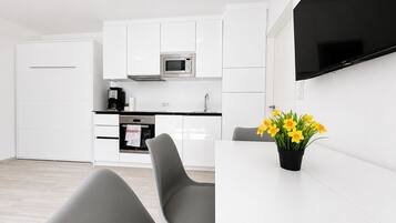 Business Apartment | Living area | Flat-screen TV, heated floors
