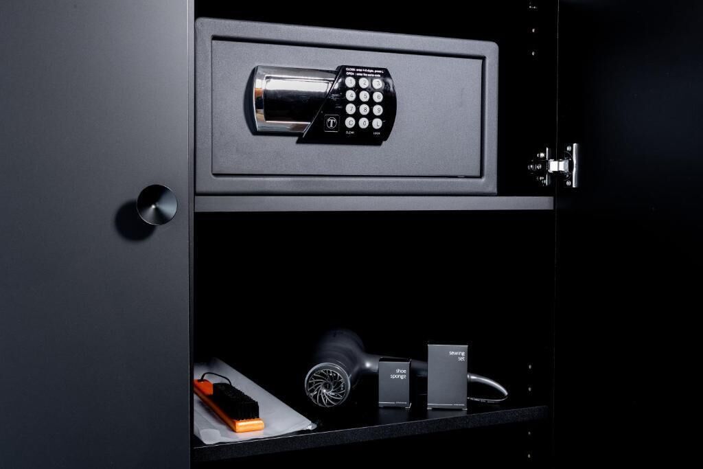 A secure storage unit with a combination lock, a shoe cleaning kit, and a small box labeled 'Shoe Sponge.'