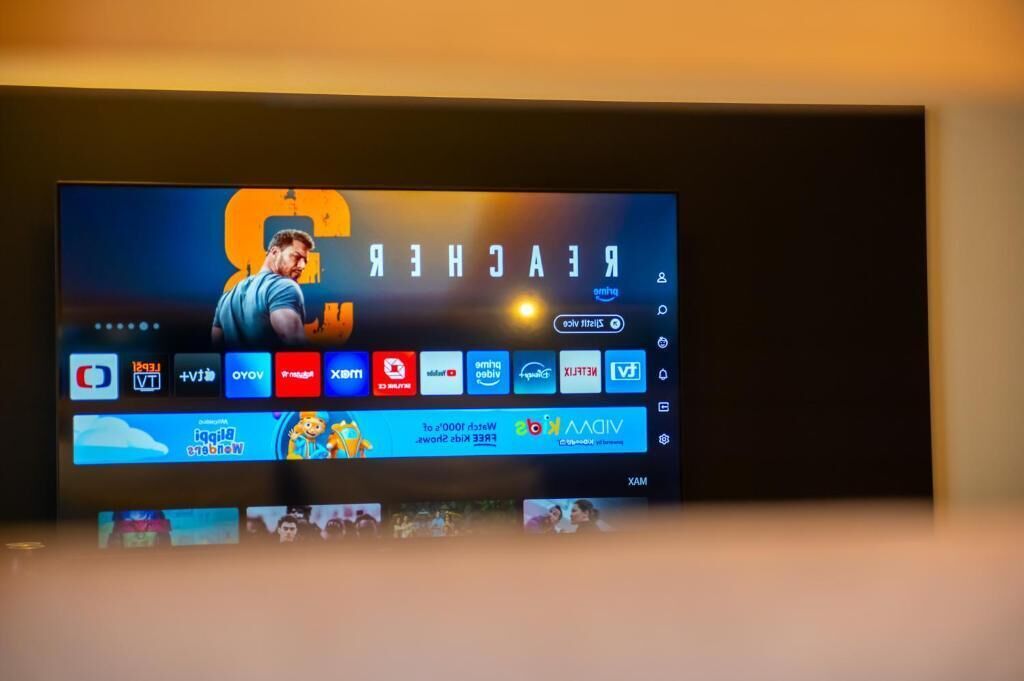 A television screen displaying a video game interface with various app icons and a character.
