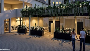 A modern building with a covered outdoor area, large windows, and potted plants. - LAKE Loft Leaf - Pflummernhaus (Überlingen)