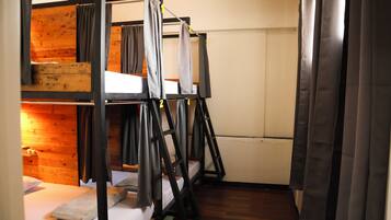 A bunk bed room with a wooden wall and a white door.