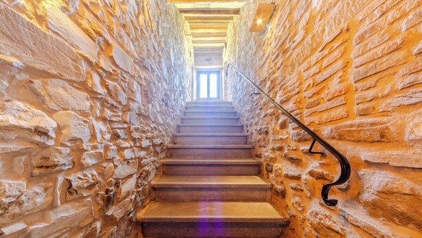 A stone staircase with a metal handrail leading to a bright interior. - A cosy farmhouse surrounded by nature! (Marche)