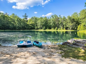 A calm lake with boats docked on the shore, surrounded by dense forest. - Theater Room Hot Tub Game Room Near Ski Resorts (Albrightsville)
