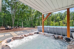 A hot tub area with a wooden deck, outdoor seating, and a pool. - Dog Friendly Farmhouse w Pool Hot Tub Fire Pit (East Stroudsburg)