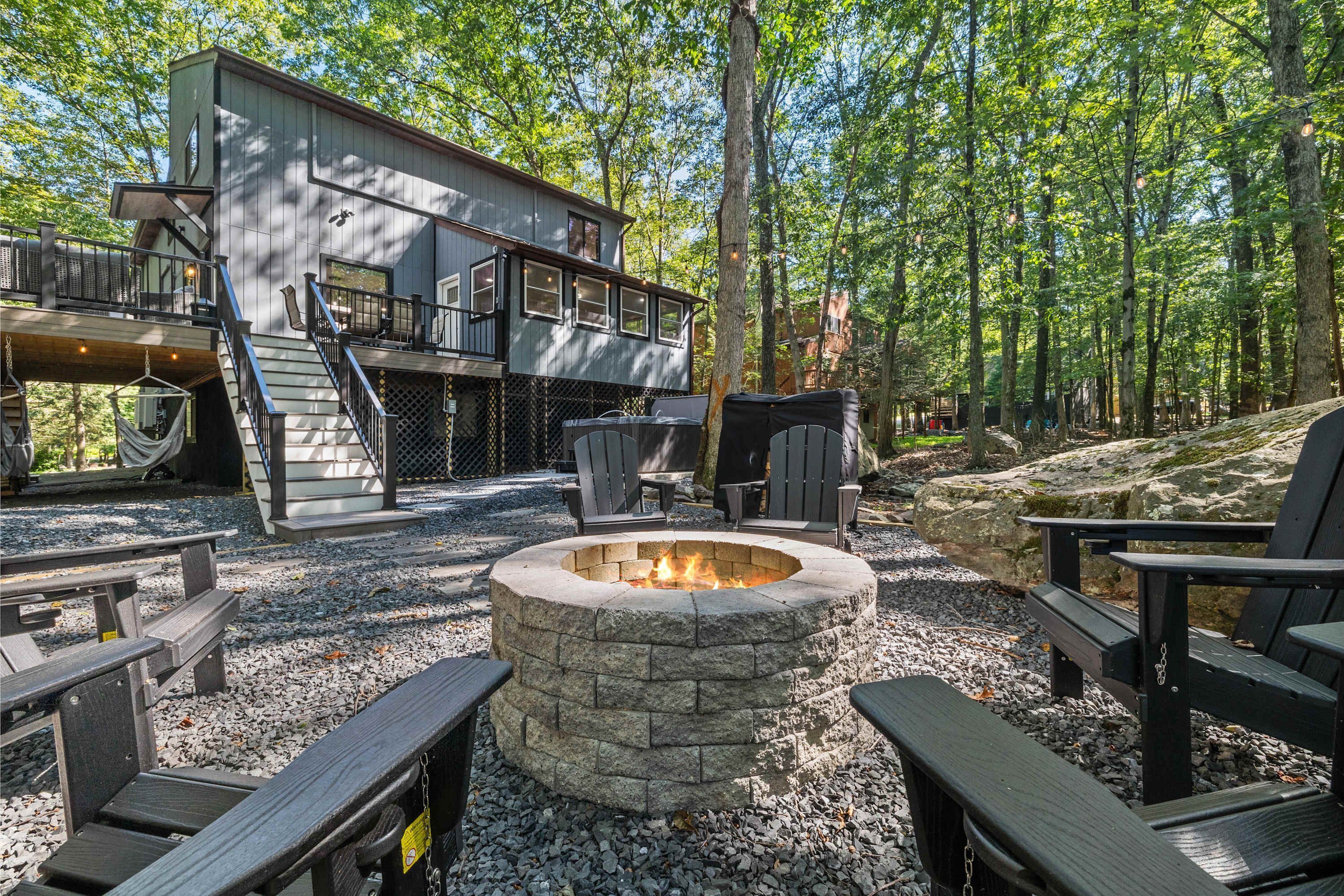 A cabin with a fire pit, outdoor seating, and a deck.