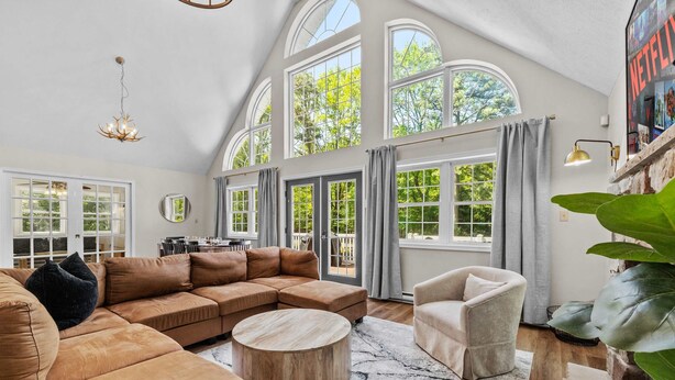 A spacious living room with a large sectional sofa, a round coffee table, and a comfortable armchair. - Game Room A C Dog-friendly Stay With Hot Tub (Albrightsville)