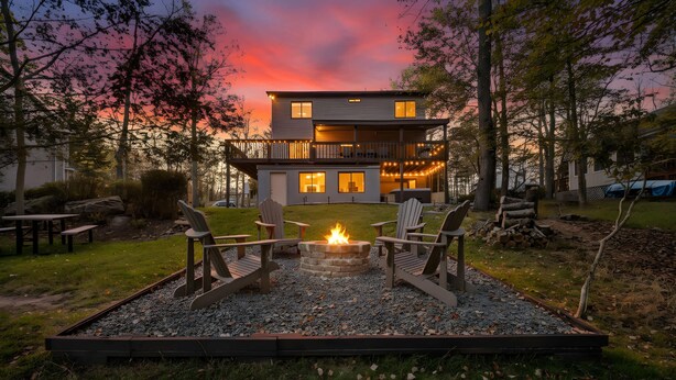 A modern two-story house with a deck, a fire pit, and outdoor seating. - Streamside Hot Tub Dog Friendly Resort Access (Pocono Lake)