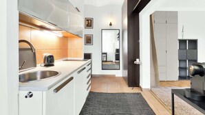 Een moderne keuken met een spoelbak, broodrooster en keukenkastjes.