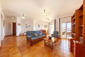Ein Wohnzimmer mit einer Couch, einem Couchtisch und einem Bücherregal.