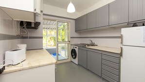 A kitchen with a washing machine, a sink, and a refrigerator. - A72 - Praia da Luz Coast Flat (Praia da Luz)