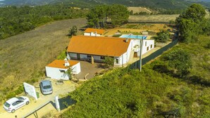 A residential property with a large house, a swimming pool, and a fenced yard.