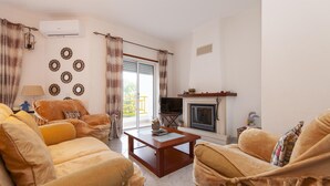 A living room with a sofa set, a coffee table, a fireplace, and decorative wall art. - B102 -  Sol Sol Lagos Apartment (Lagos)