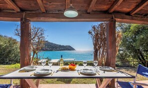 A table set for two with a view of the sea and mountains. - Villa Gilda - Five Bedroom Villa, Sleeps 10 (Torre Delle Stelle (Maracalagonis))