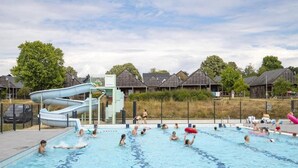A swimming pool with a water slide, surrounded by houses. - Les Lodges de Sainte-Suzanne (Sainte-Suzanne-and-Chammes)
