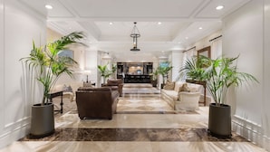 A spacious lobby with a marble floor, leather sofas, and large potted plants. - Pool View Suite | Beachside Resort (Key West)