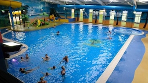 An indoor swimming pool with multiple lanes, slides, and play areas. - Elegant 2 Bed One and Half Bath Caravan (Northampton)