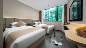 A modern hotel room with two beds, a large window with a view of greenery, a wooden desk, and a mirror. - Lofi Hotel - Pazhou Canton Fair Center (Guangzhou)