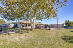 A residential property with a fenced yard, a covered patio, and a house with a chimney. - Private Pool • Fenced Yard • Covered Patio (Decatur)