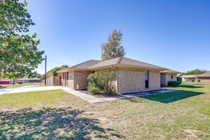 A single-story house with a brick exterior, a front porch, and a small front yard. - Private Pool • Fenced Yard • Covered Patio (Decatur)