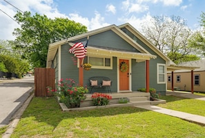 A single-story house with a porch, a front door, and a small garden with flowers. - Kid friendly + 3 blocks from Decatur Courthouse! (Decatur)