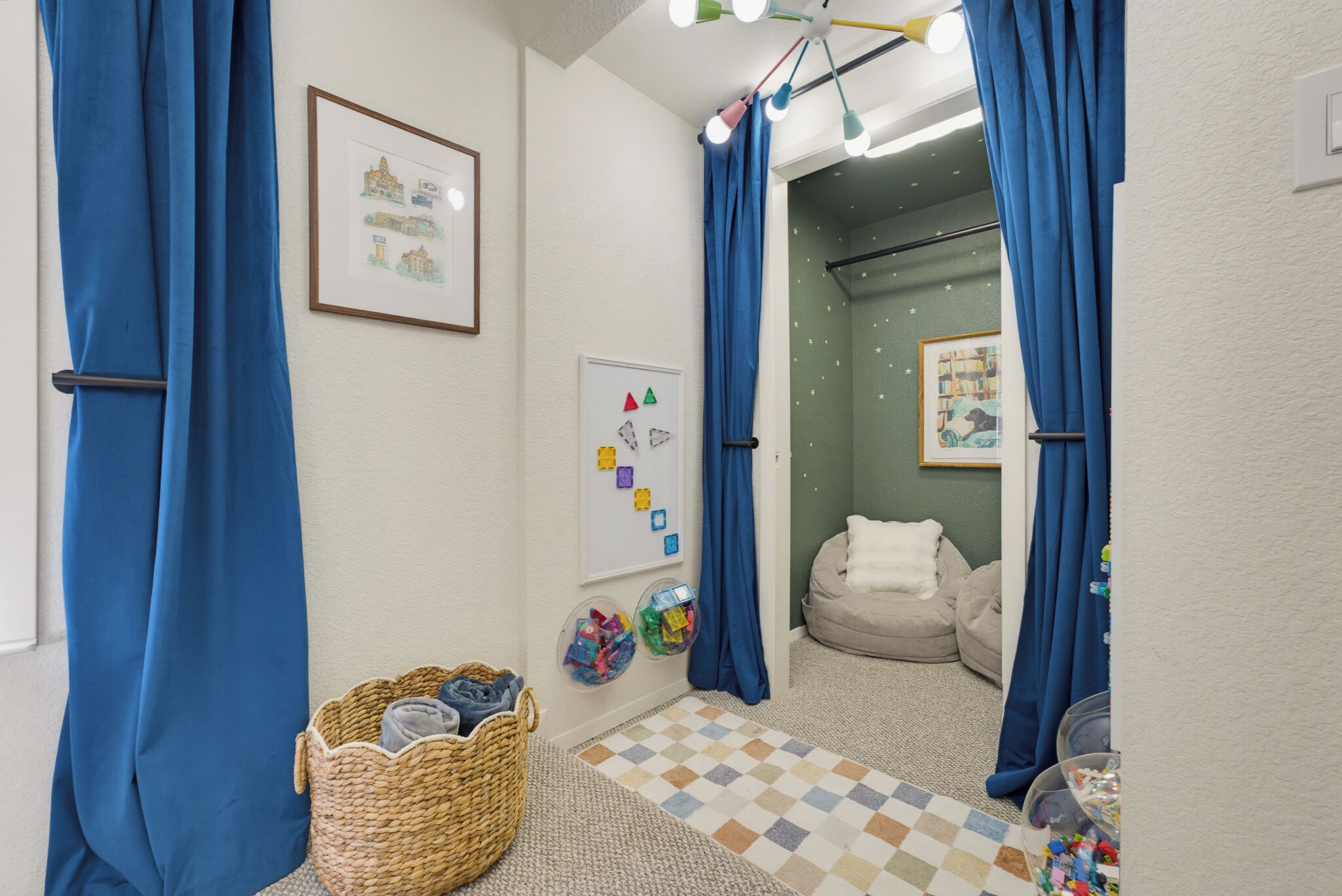 A bathroom with a checkered floor, a wicker basket, a whiteboard, and a dog bed.