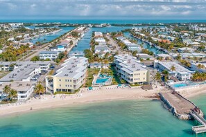 A coastal resort with multiple buildings, a beach, and a marina. - *NEW* Coral Sands Oceanfront-Beach & Pool (Key Colony Beach)