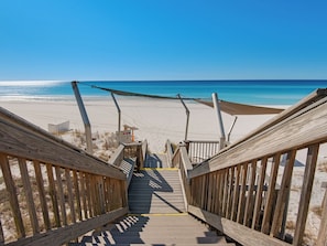 A wooden staircase leading to a beach with a clear view of the ocean. - Wonderful Gulf Front Condo at Hidden Dunes (Miramar Beach)