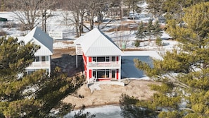 A two-story building with a red and white facade, a balcony, and a sign indicating a campground.