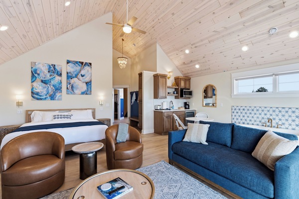 Open studio with king bed kitchenette and coastal artwork