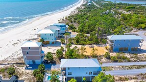 A coastal property with multiple buildings, a beach, and a clear view of the ocean. - Sand Casas (Port St. Joe)
