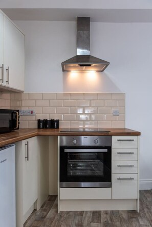 Fridge, microwave, oven, stovetop - Contractor Room • Kitchen • Central Spot (Neath Port Talbot Principle Area)