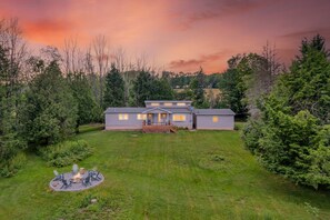 A two-story house with a deck, surrounded by a well-maintained lawn and dense trees. - Mountain Views Private Pond Mins 2 Elk Mountain (Union Dale)