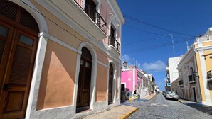 A cobblestone street lined with historic buildings, featuring arched doorways and balconies. - Loft Studio in San Sebastián St. next to Old San Juan Nightlife (San Juan)
