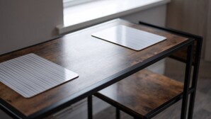 A wooden table with two white placemats.