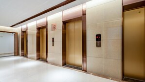 A modern elevator area with metallic doors and digital displays. - Anara Aparthotel Chengdu Chunxi Road (Chengdu)