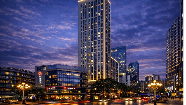 A high-rise building with a modern design, surrounded by other tall buildings, and a busy street with moving vehicles. - Anara Aparthotel Chengdu Chunxi Road (Chengdu)