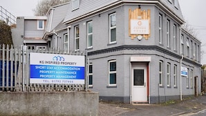 A multi-story building with a sign for KG Inspired Property, offering short stay accommodation, property maintenance, and management. - Contractor Base • Kitchen • Parking Included (Plasmarl)