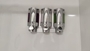 A wall-mounted dispenser with three compartments labeled 'shampoo,' 'conditioner,' and 'shower gel.' - Private En-Suite • TV • Fridge • Microwave (Saint Thomas)