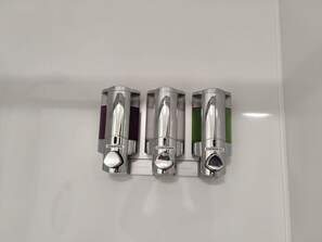 A wall-mounted dispenser with three compartments labeled 'shampoo,' 'conditioner,' and 'shower gel.' - Private En-Suite • TV • Fridge • Microwave (Saint Thomas)