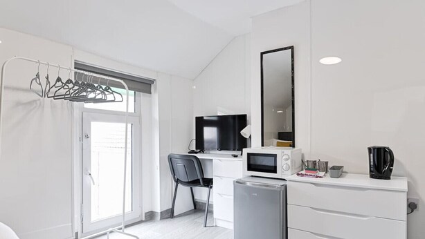 A modern kitchenette with a microwave, coffee maker, and a small refrigerator. - Private En-Suite • TV • Fridge • Microwave (Saint Thomas)