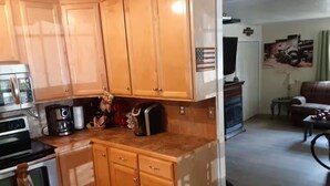 A kitchen with wooden cabinets, a coffee maker, and a toaster. - Creekside Garage Getaway  (Robbinsville)