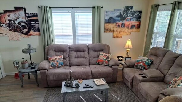 A living room with a brown sofa set, a coffee table, and a lamp. - Creekside Garage Getaway  (Robbinsville)