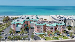 A beachfront hotel with multiple buildings, a parking lot, and a beach in the background. - Family Friendly w/ Balcony and Shared Pool BC1314 (Indian Shores)